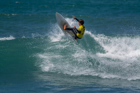 Surfer in Ribeira de Ilhas Beach in Ericeira Portugal.