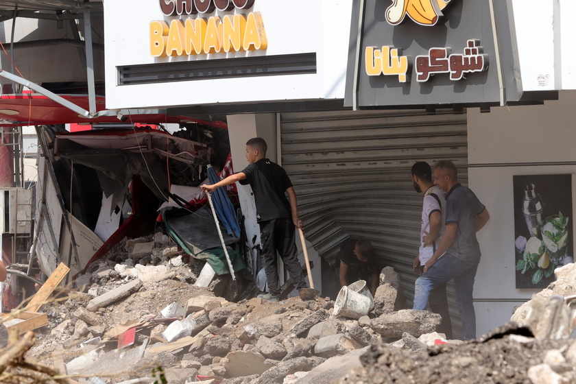 Palestinians inspect the damage after a 10-day Israeli military operation in West Bank's Jenin