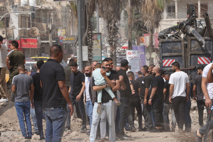 Palestinians inspect the damage after a 10-day Israeli military operation in West Bank's Jenin