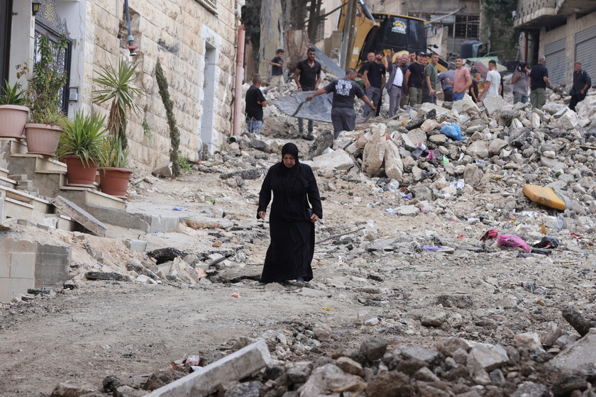 Palestinians inspect the damage after a 10-day Israeli military operation in West Bank's Jenin