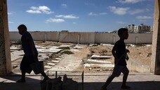 Palestinians make graves from the rubble of Gaza's destroyed homes